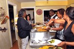 Guests serve themselves from food station