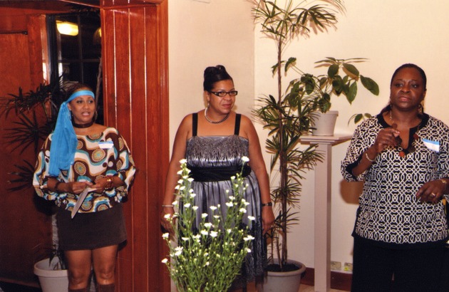 Three women stand at dinner party