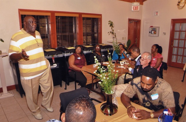 Larry Little speaking to guests