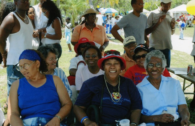 Women sitting in shade at event