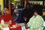 Garth C. Reeves laughing with two other guests