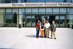 Five people posing in front of museum