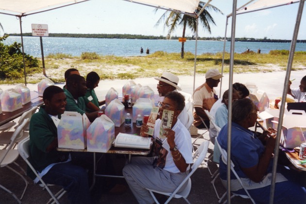 Several people eating lunch at tables