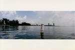 Photo of a buoy off of Virginia Key Beach with Fisher Island and South Beach in the background.