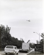[1970/1990] Reticulated giraffe being escorted by zoo security to Miami Metrozoo
