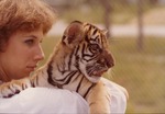Bengal tiger cub being held by zookeeper at Miami Metrozoo