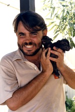 [1980/2000] Two young piglets being held by a zookeeper at Miami Metrozoo