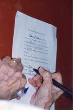 Eileen Davis signing a birds of prey certification letter with supervisor Lisa Marshall and trainer Joy Stahl's signatures