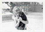 [1967] Young zoo guest holding a young Celebes crested macaque named Ralph at Crandon Park Zoo