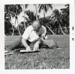 Aardvark climbing on the arm of Albert Staehle while he draws at Crandon Park Zoo