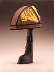 [1925] [Lamp base with kneeling female and face motif and silk lampshade with batik decoration, ca. 1925]