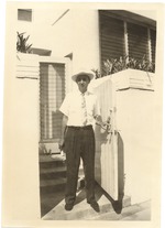 [1950/1959] Man standing next to gate