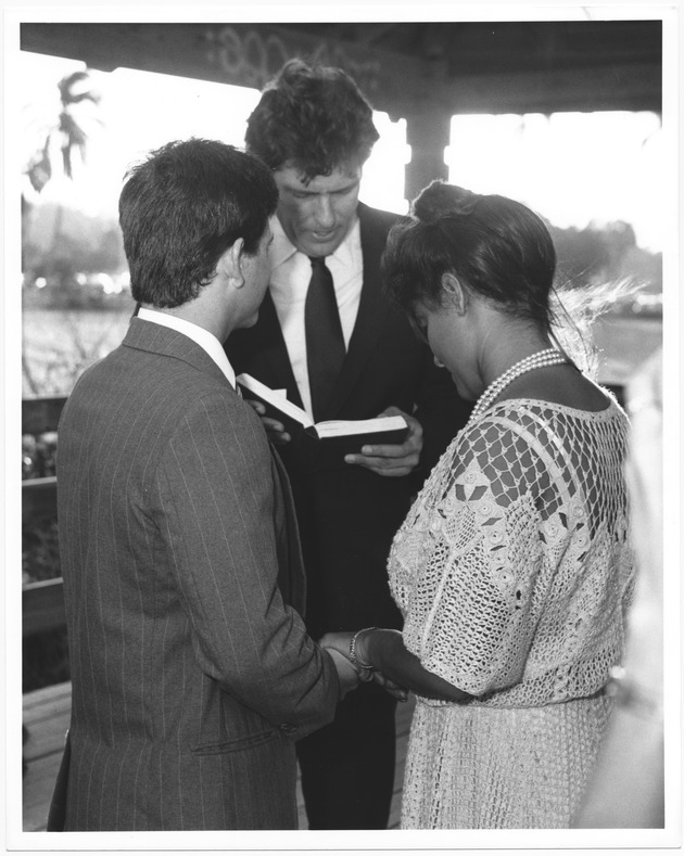 Mayor Alex Daoud officiating at wedding ceremonies, 1987 - Photograph, recto: [Mayor Alex Daoud reading vows]
