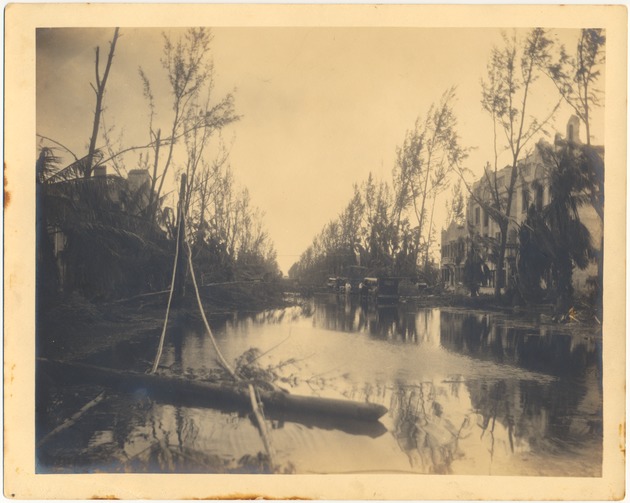 Miami Beach after the 1926 hurricane - Photograph, recto: [Flooded street and stranded cars in a residential section of Miami Beach, September 19, 1926]