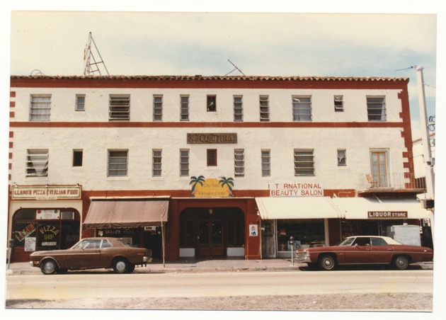 The Clay Hotel and storefronts for Llano's Pizza and International Beauty Salon