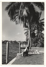 [1954/12] Woman poses in front of palm tree