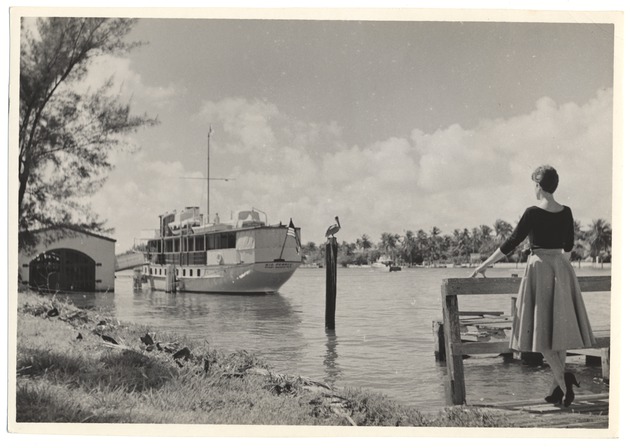 Sandi Justis poses in front of boat