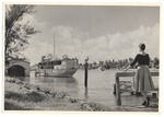 Sandi Justis poses in front of boat