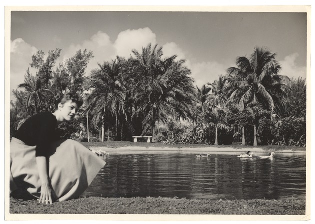 Sandi Justis crouching by pond