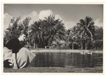 Sandi Justis crouching by pond