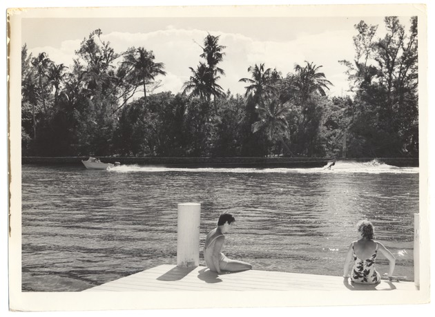 Two women sitting on dock