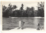 Two women sitting on dock