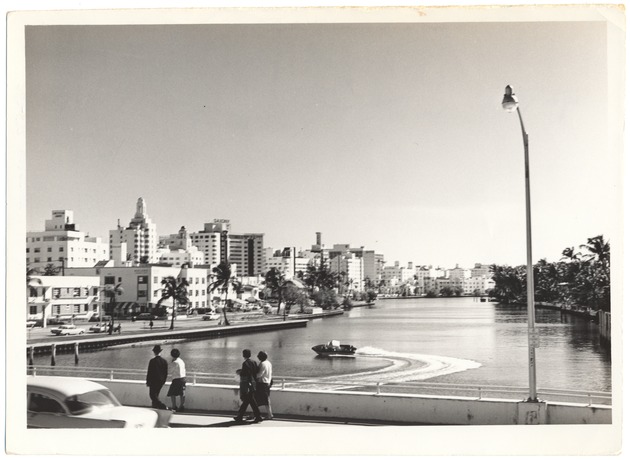 Miami Beach hotels and residences along Indian Creek - Photograph, recto: [Waterway scene. The Croydon Apartments building and the Cadillac, the Versailles and the Saxony hotels in the background, looking south from 41st street bridge]