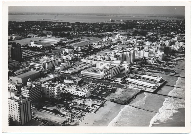 Looking north from the ocean at Sixteenth Street showing the St. Moritz, Sands, New Yorker, and Nautilus Hotels, as well as Lincoln Road, Temple Emmanuel and the Julia Tuttle Causeway - 