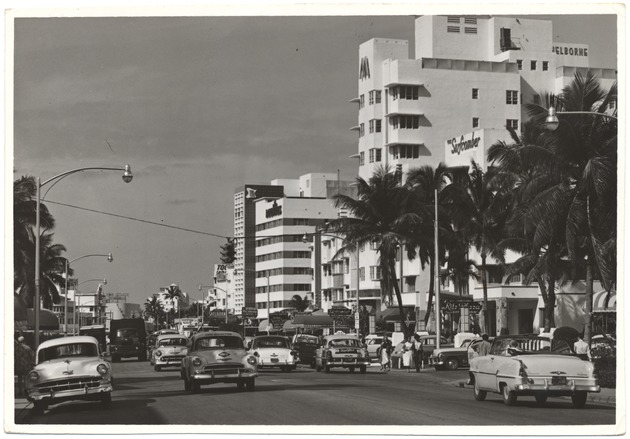 1950s Promotional photographs of hotels - Photograph recto: [Looking north from Collins Avenue at Seventeenth Street, showing the Surfcomber, Sherborne, Nautilus, and Marseilles Hotels, February 1954]