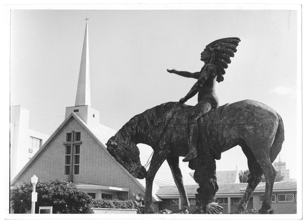 The Great Spirit statue at Forty-first Street and Pinetree Drive - Photograph, recto: ["The Great Spirit" statue at Forty-first Street and Pine Tree Drive, All Souls Episcopal Church pictured at right].