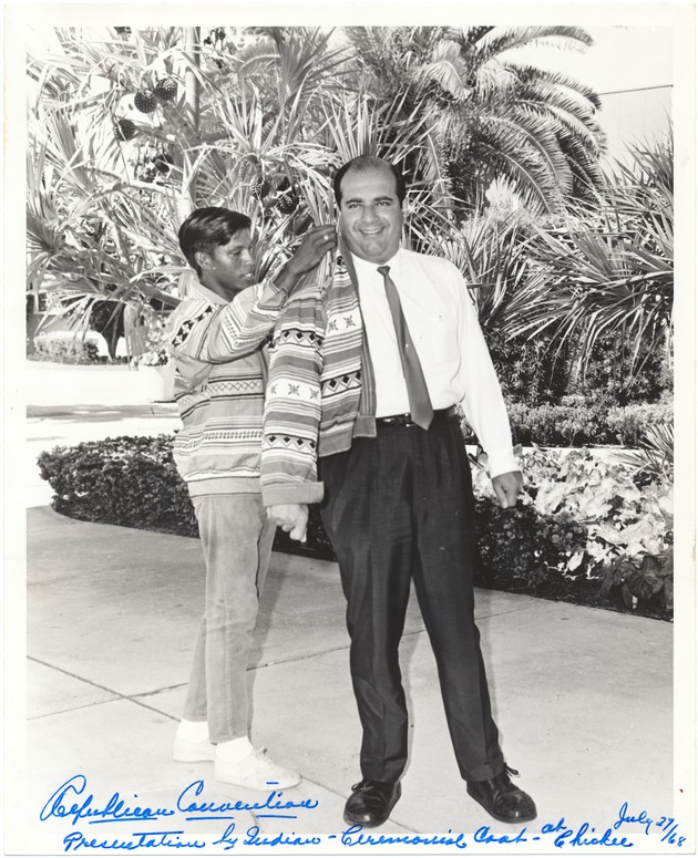 Mayor Jay Dermer, "The Walking Mayor" - Photograph, recto: [Mayor Jay Dermer is presented with an Indian Ceremonial Coat at Chickee by Roy Express during the 1968 Republican National Convention, July 27, 1968]