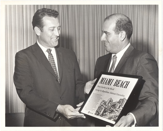Miami Beach Mayor Jay Dermer at city events, 1968 - Photograph, recto: [Head of SouthBell Mac Gilstrap presenting the front cover of South Bell to Mayor Jay Dermer. The cover reads "Miami Beach, News Capital of the World, during the Republican National Convention," 1968]