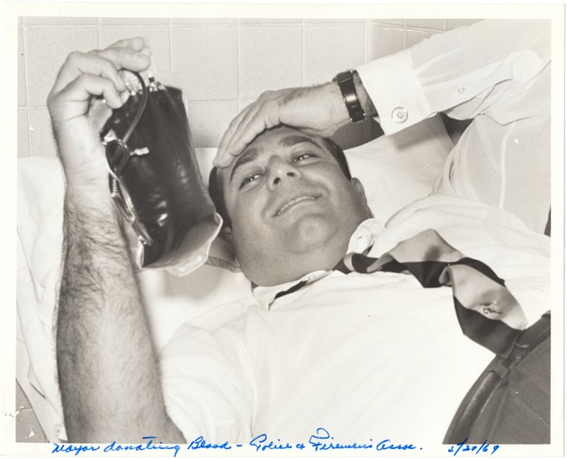 Miami Beach Mayor Jay Dermer at city events, models of the Collins Avenue Building - Photograph, recto: [Mayor Jay Dermer donating blood at Mt. Sinai Hospital, May 20, 1969]
