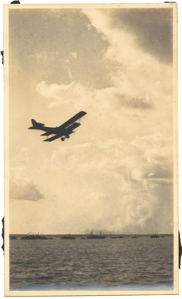 Airplane performing above a boat during a regatta