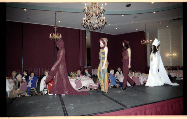 Guests watch models on runway