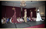 Guests watch models on runway
