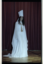 Model in white dress on stage