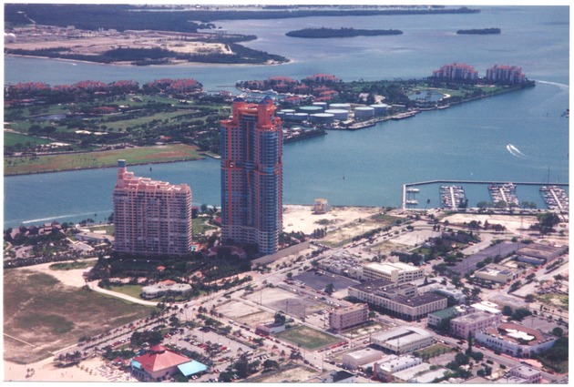 Aerial views of Miami Beach looking north and south and Fisher Island - Photograph, recto: [Aerial view of the Portofino Tower (opened in 1997) in South Beach, looking southeast. Fisher Island in the back] 