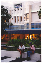 People sitting in front of the Sterling Building on Lincoln Road