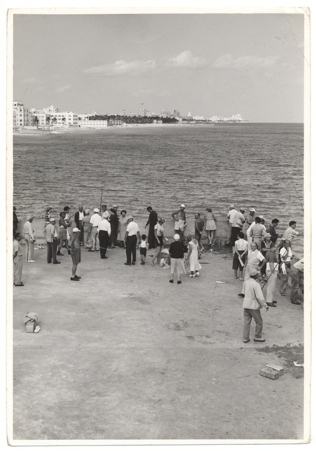 People off the pier at Friendship Corner with Miami Beach Hotels and coastline in the background