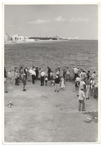 People off the pier at Friendship Corner with Miami Beach Hotels and coastline in the background