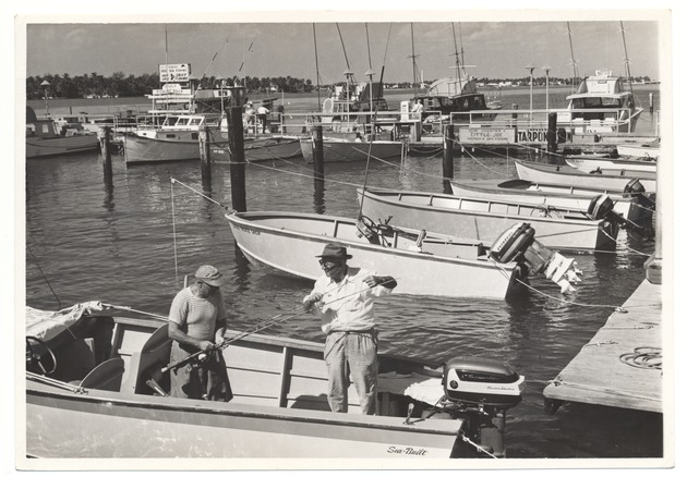 Men in a boat, preparing to fish