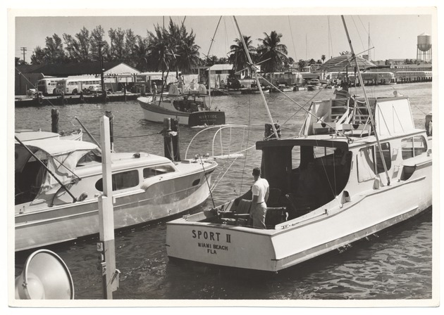 Boats near the docks, including the "Sport II"