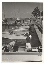 Two men in a boat at the docks