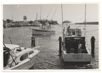 Boats leaving the docks, including the "Sport II"