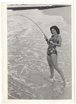 Woman in bathing suit enjoying fishing on the beach