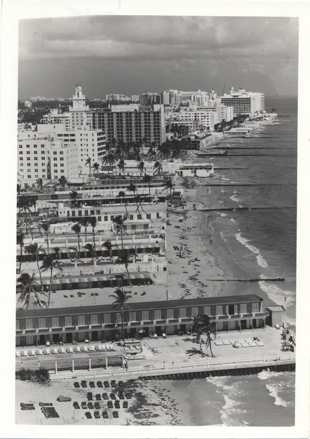 Beach and cabanas from Seventeenth to Nineteenth Street, with the Holiday Inn (under construction?), Roney Plaza, and Seville Hotel in the background - 