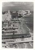 Beach and cabanas from Seventeenth to Nineteenth Street, with the Holiday Inn (under construction?), Roney Plaza, and Seville Hotel in the background
