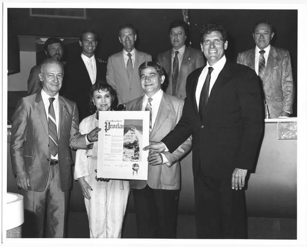 Miami Beach Mayor Alex Daoud presenting proclamations and keys to the city to various people, 1980s - Photograph, recto: [Mayor Alex Daoud presenting proclamation]