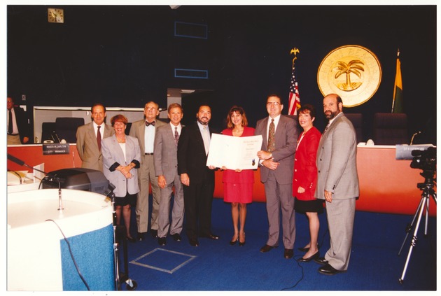 Miami Beach Mayor Seymour Gelber and City Commission presentations, 1990s - Photograph, recto: [Female receiving Certificate of Appreciation from the City of Miami Beach].